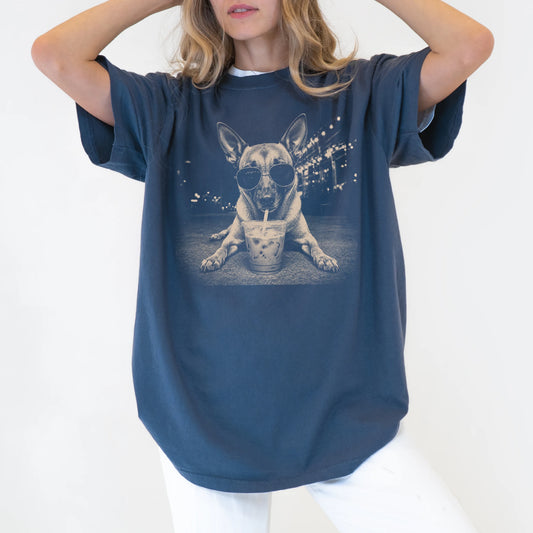 Model wearing a Denim Comfort Colors® T-shirt featuring Belgian Malinois with iced coffee in a retro grunge design