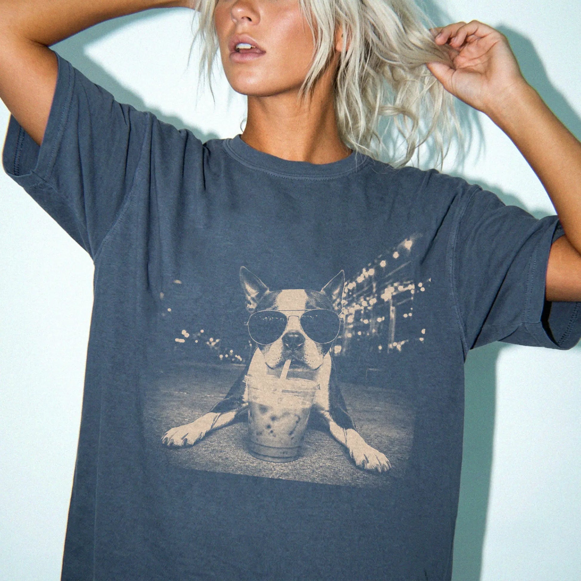 Model wearing a Denim Comfort Colors® T-shirt featuring Boston Terrier with iced coffee in a retro grunge design