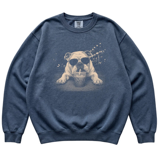 Bulldog wearing aviator sunglasses and drinking iced coffee on a Denim Comfort Colors 1566 Sweatshirt, flat lay view