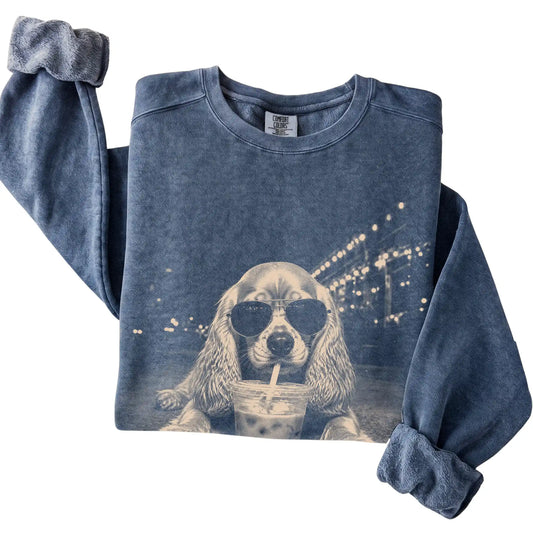Cocker Spaniel wearing aviator sunglasses and drinking iced coffee on a Denim Comfort Colors 1566 Sweatshirt, folded view