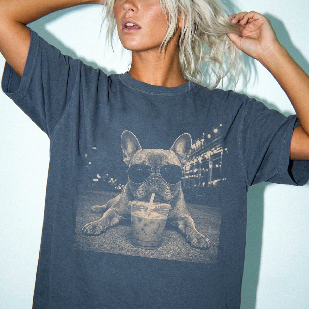 Model wearing a Denim Comfort Colors® T-shirt featuring French Bulldog with iced coffee in a retro grunge design
