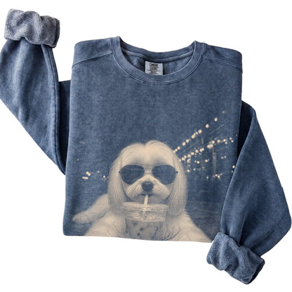 Maltese wearing aviator sunglasses and drinking iced coffee on a Denim Comfort Colors 1566 Sweatshirt, folded view