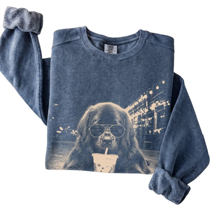 Newfie wearing aviator sunglasses and drinking iced coffee on a Denim Comfort Colors 1566 Sweatshirt, folded view