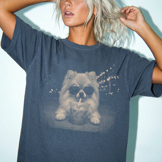 Model wearing a Denim Comfort Colors® T-shirt featuring Pomeranian with iced coffee in a retro grunge design