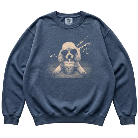 Poodle wearing aviator sunglasses and drinking iced coffee on a Denim Comfort Colors 1566 Sweatshirt, flat lay view