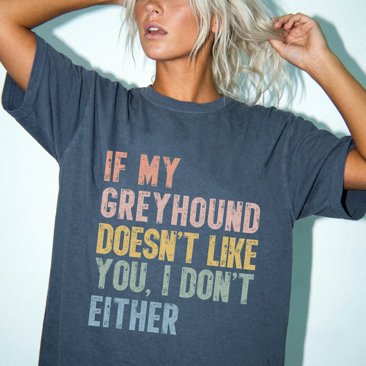 Model wearing a Denim Comfort Colors® T-shirt featuring Greyhound with “If My Dog Doesn’t Like You, I Don’t Either” lettering