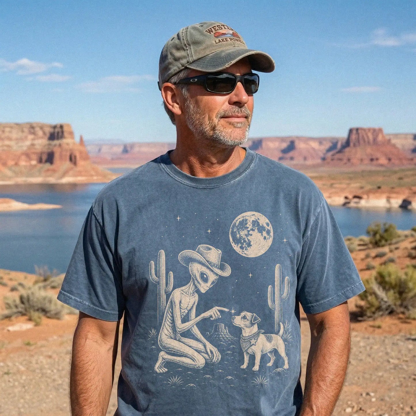 Model wearing a Denim Comfort Colors® T-shirt with cowboy alien fist-bumping a jack russell beneath the moon