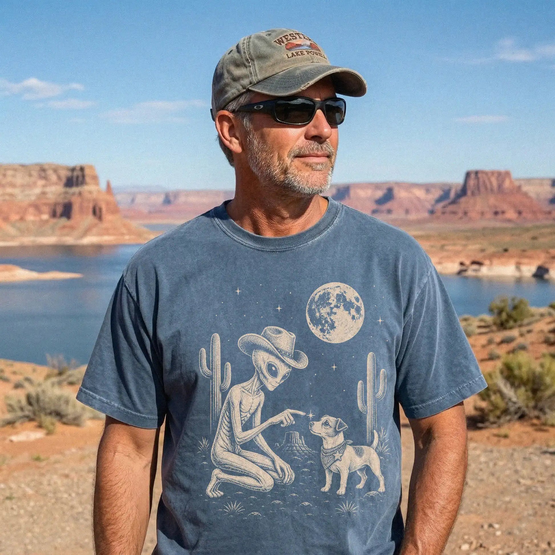 Model wearing a Denim Comfort Colors® T-shirt with cowboy alien fist-bumping a jack russell beneath the moon