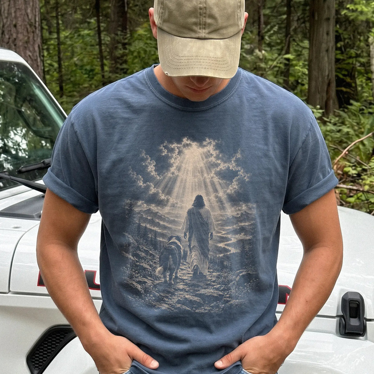 Person wearing a Denim T-shirt with Jesus walking beside a Bernese Mountain Dog beneath rays of light