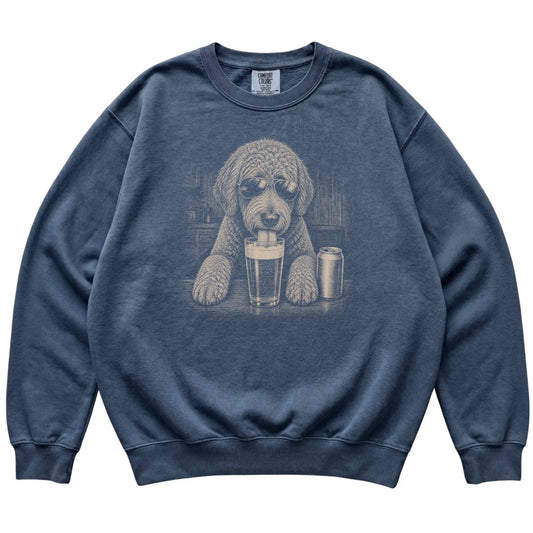 Denim Labradoodle drinking from a pint at a bar, laid flat