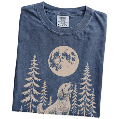 Folded Denim Comfort Colors® T-shirt showing a Labradoodle howling beneath the moon and pine trees
