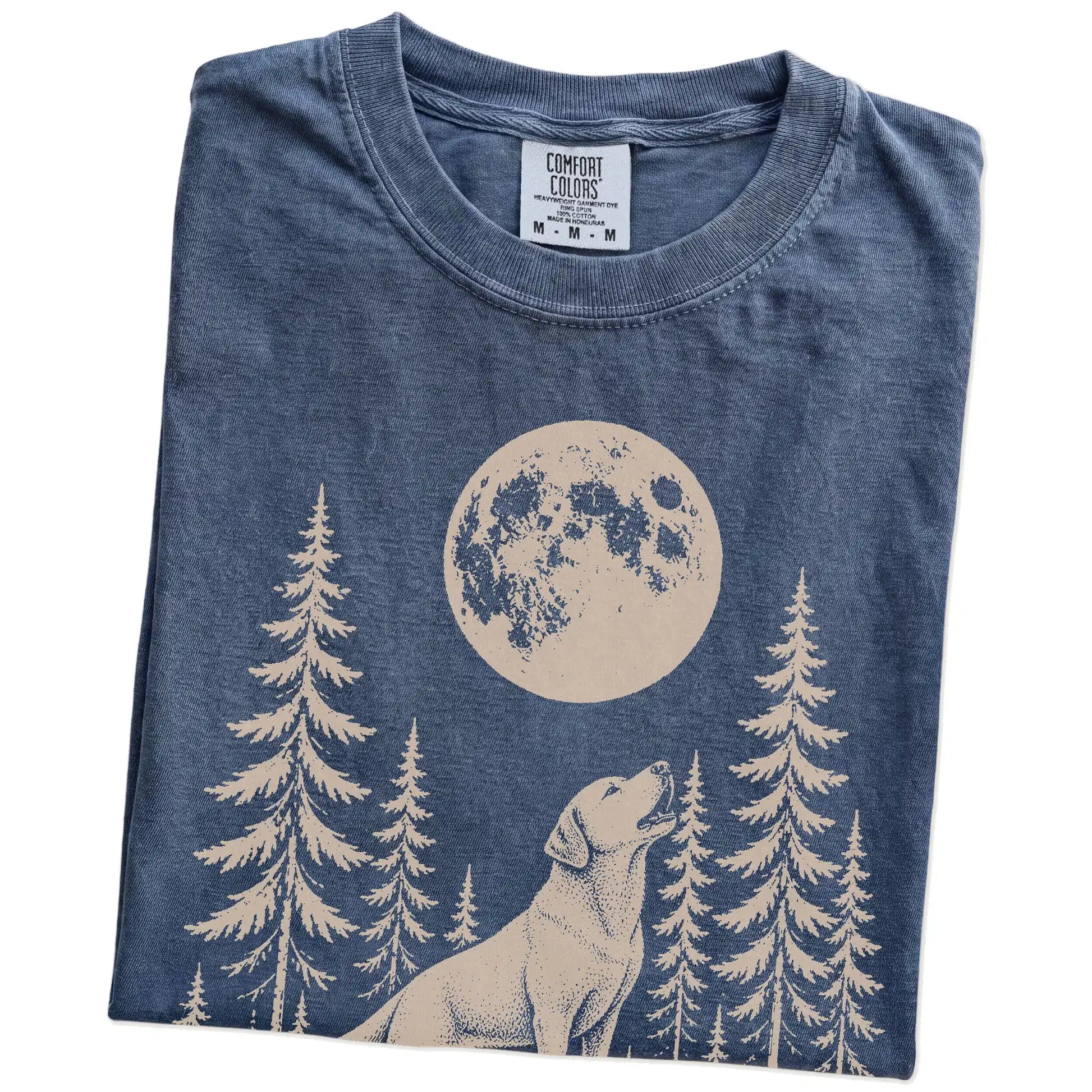 Folded Denim Comfort Colors® T-shirt showing a Labrador Retriever howling beneath the moon and pine trees