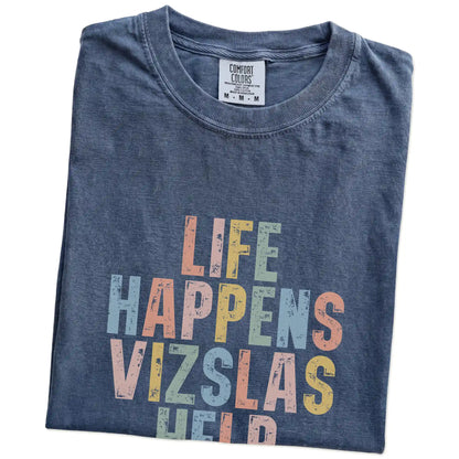 Folded Denim Comfort Colors® T-shirt showing retro “Life Happens, Vizslas Help” lettering