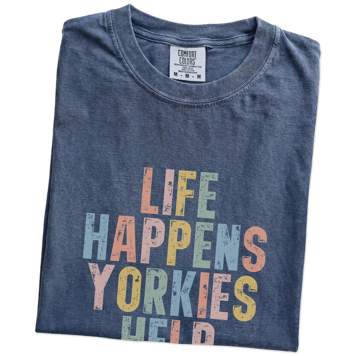 Folded Denim Comfort Colors® T-shirt showing retro “Life Happens, Yorkies Help” lettering