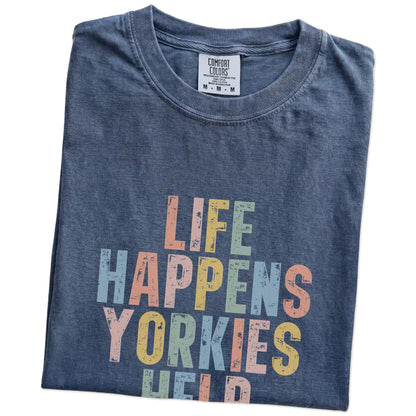 Folded Denim Comfort Colors® T-shirt showing retro “Life Happens, Yorkies Help” lettering