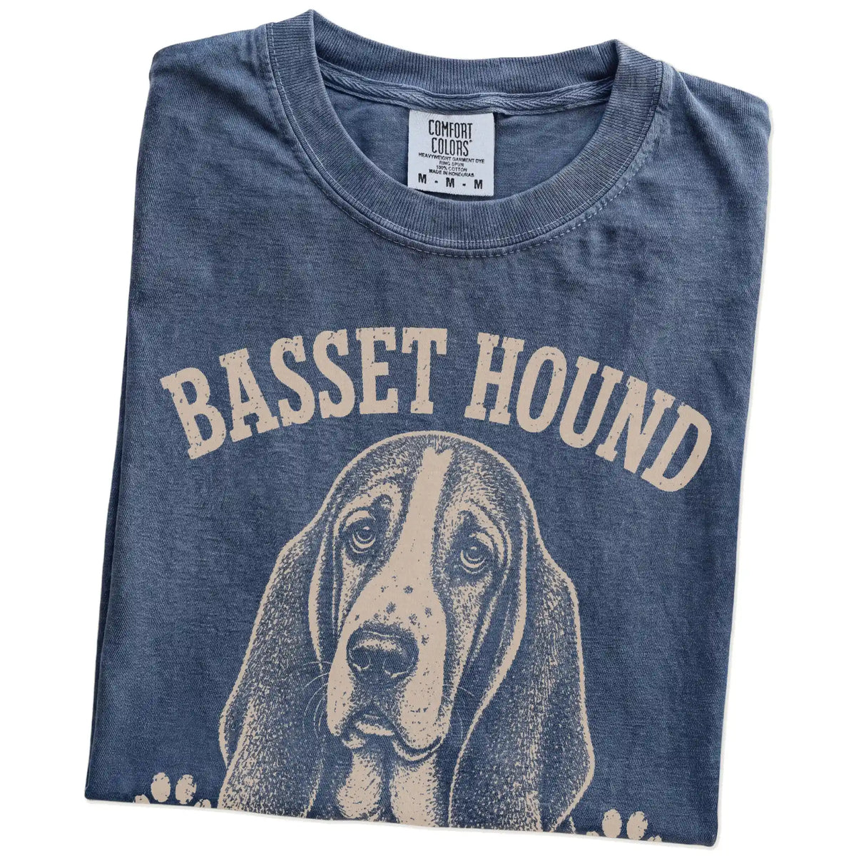 Folded Denim Comfort Colors® T-shirt showing Basset Hound design with “Low Energy, High Standards” lettering