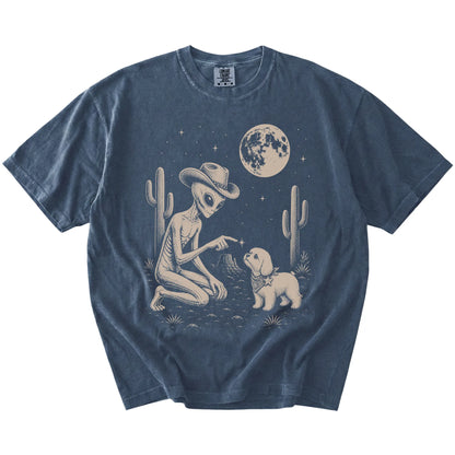 Cowboy alien fist-bumping a Maltese beneath the moon on a Denim Comfort Colors® T-shirt