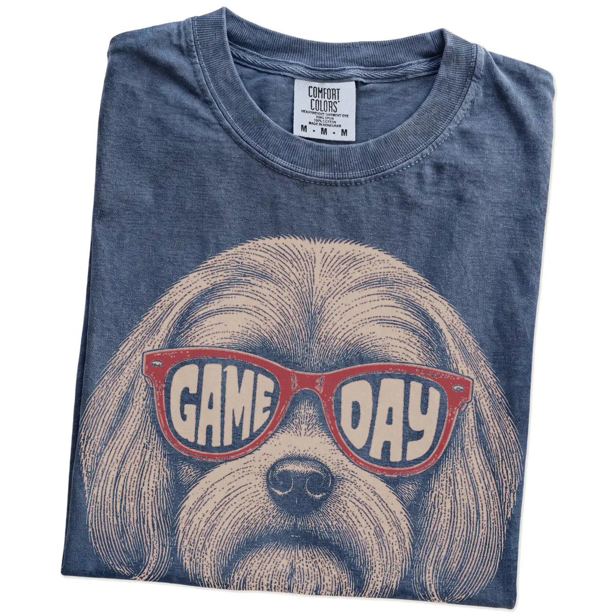 Folded Denim Comfort Colors® T-shirt showing maltese wearing red game day sunglasses