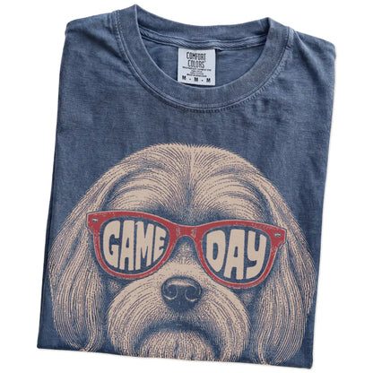 Folded Denim Comfort Colors® T-shirt showing maltese wearing red game day sunglasses