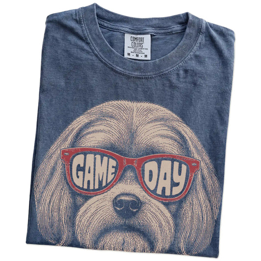 Folded Denim Comfort Colors® T-shirt showing maltese wearing red game day sunglasses