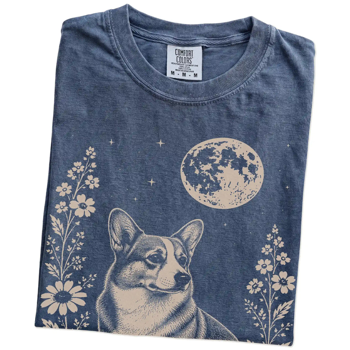 Folded Denim Comfort Colors® T-shirt showing Corgi framed by flowers beneath the moon