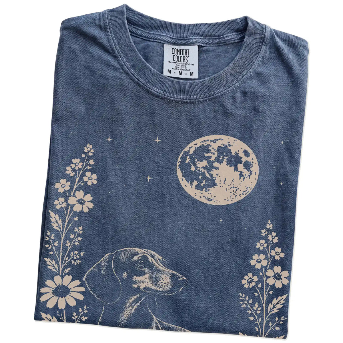 Folded Denim Comfort Colors® T-shirt showing Dachshund framed by flowers beneath the moon