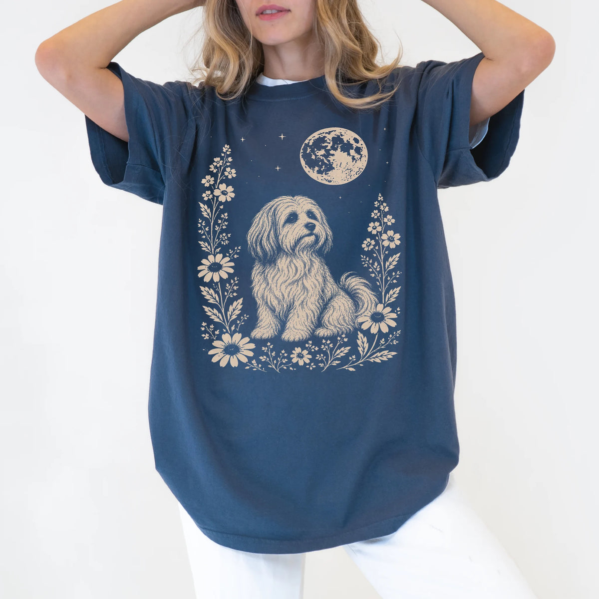 Model wearing a Denim Comfort Colors® T-shirt featuring Havanese framed by flowers beneath the moon