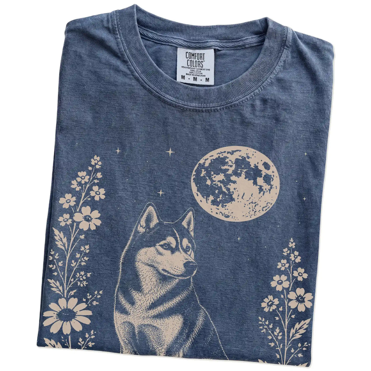 Folded Denim Comfort Colors® T-shirt showing Husky framed by flowers beneath the moon