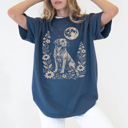 Model wearing a Denim Comfort Colors® T-shirt featuring Labrador Retriever framed by flowers beneath the moon