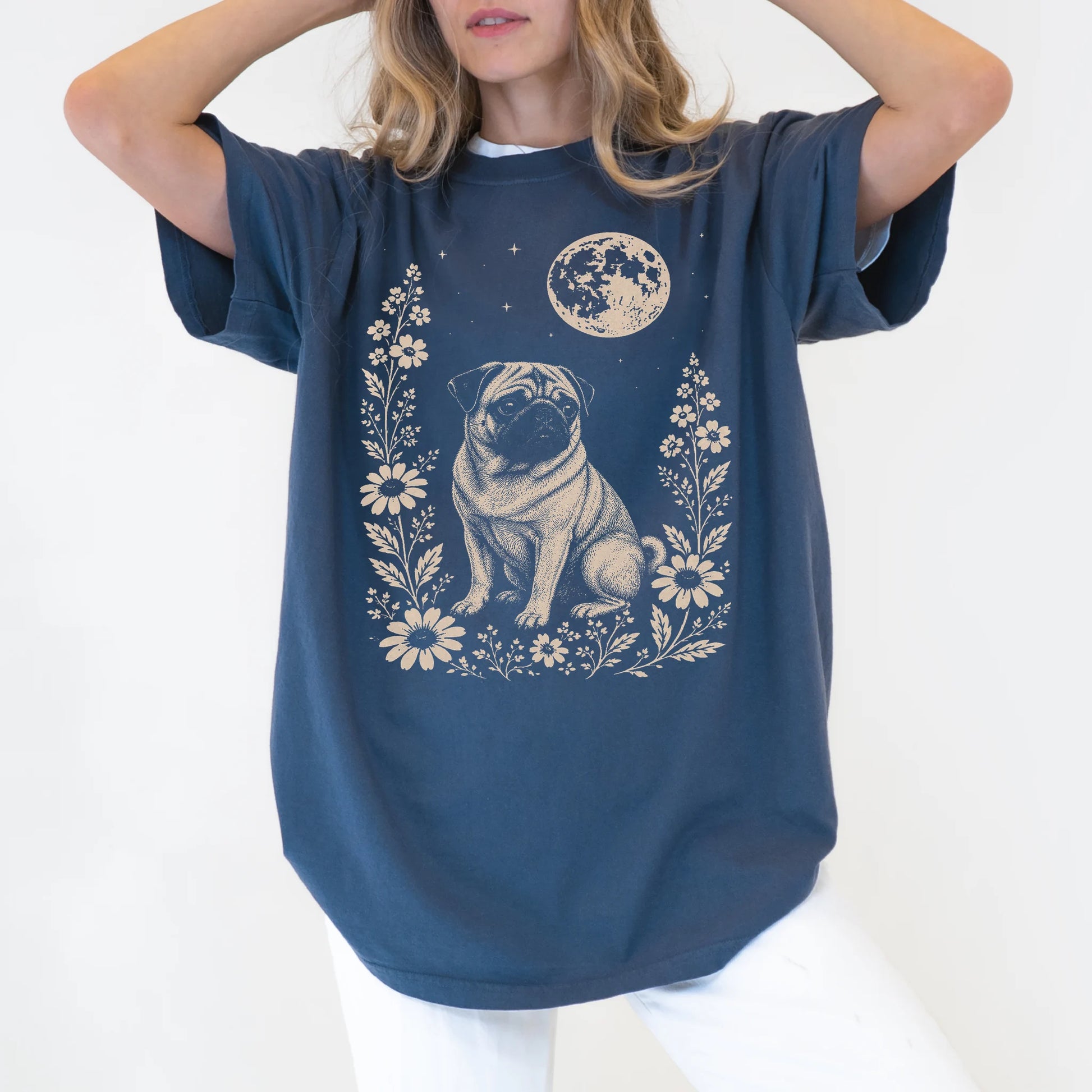 Model wearing a Denim Comfort Colors® T-shirt featuring Pug framed by flowers beneath the moon