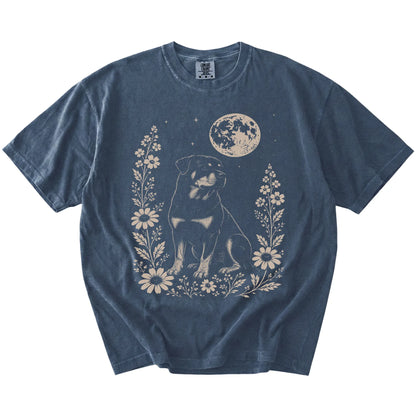 Rottweiler framed by flowers beneath the moon on a Denim Comfort Colors® T-shirt