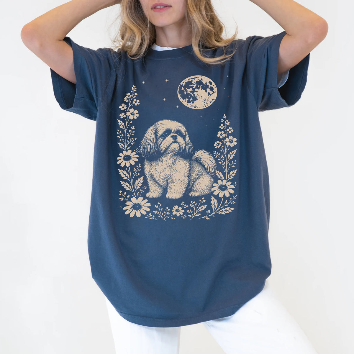 Model wearing a Denim Comfort Colors® T-shirt featuring Shih Tzu framed by flowers beneath the moon