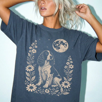 Model wearing a Denim Comfort Colors® T-shirt featuring Springer Spaniel framed by flowers beneath the moon