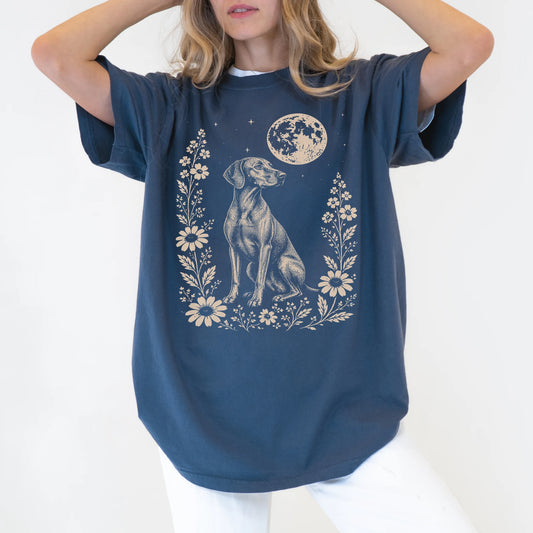 Model wearing a Denim Comfort Colors® T-shirt featuring Vizsla framed by flowers beneath the moon