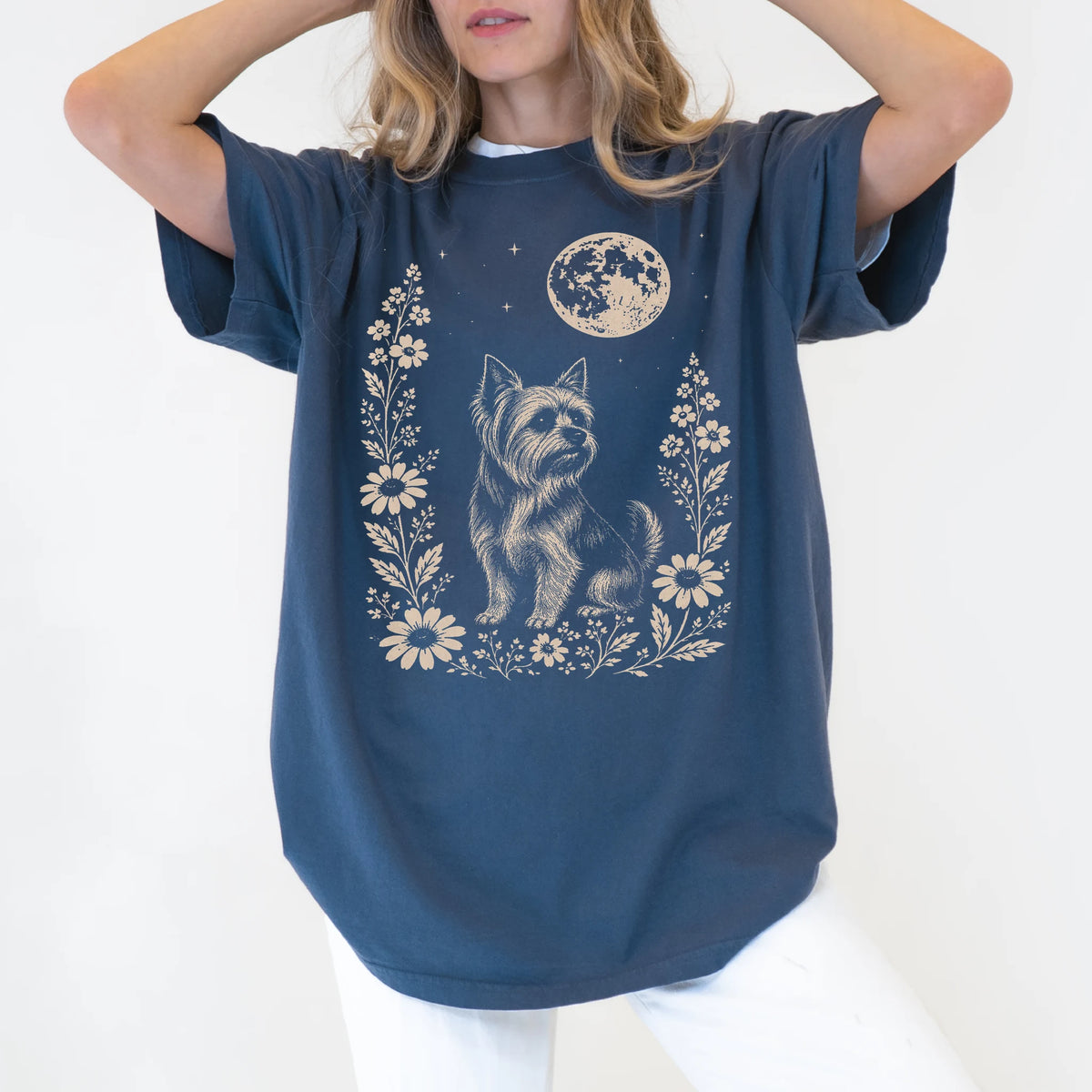 Model wearing a Denim Comfort Colors® T-shirt featuring Yorkie framed by flowers beneath the moon