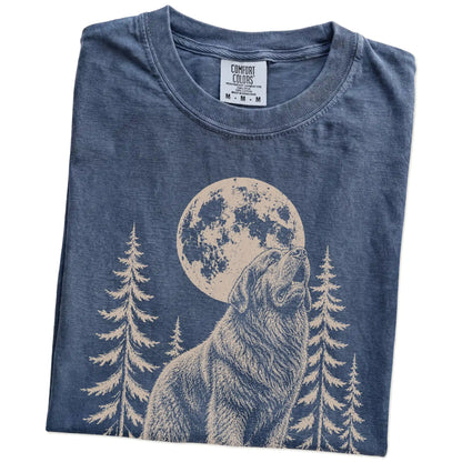 Folded Denim Comfort Colors® T-shirt showing a Newfie howling beneath the moon and pine trees