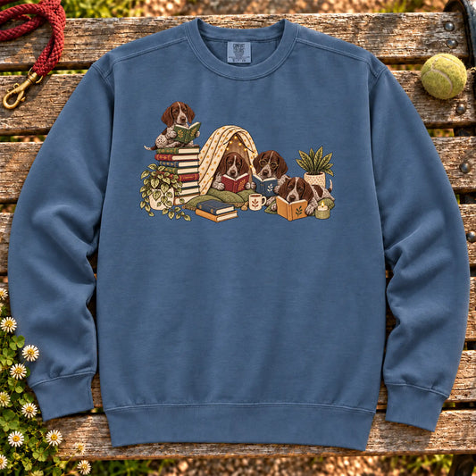 Pointer puppies reading books in a cozy blanket fort on a Denim sweatshirt