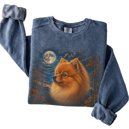 Folded denim sweatshirt with Pomeranian Autumn Moon artwork.