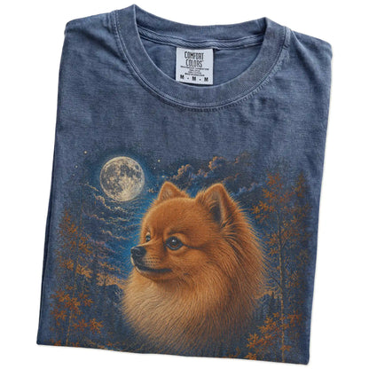 Folded denim T-shirt with Pomeranian Autumn Moon artwork.