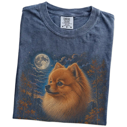 Folded denim T-shirt with Pomeranian Autumn Moon artwork.