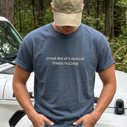 Model wearing a Denim Comfort Colors® T-shirt with proud dad of a spoiled french bulldog lettering