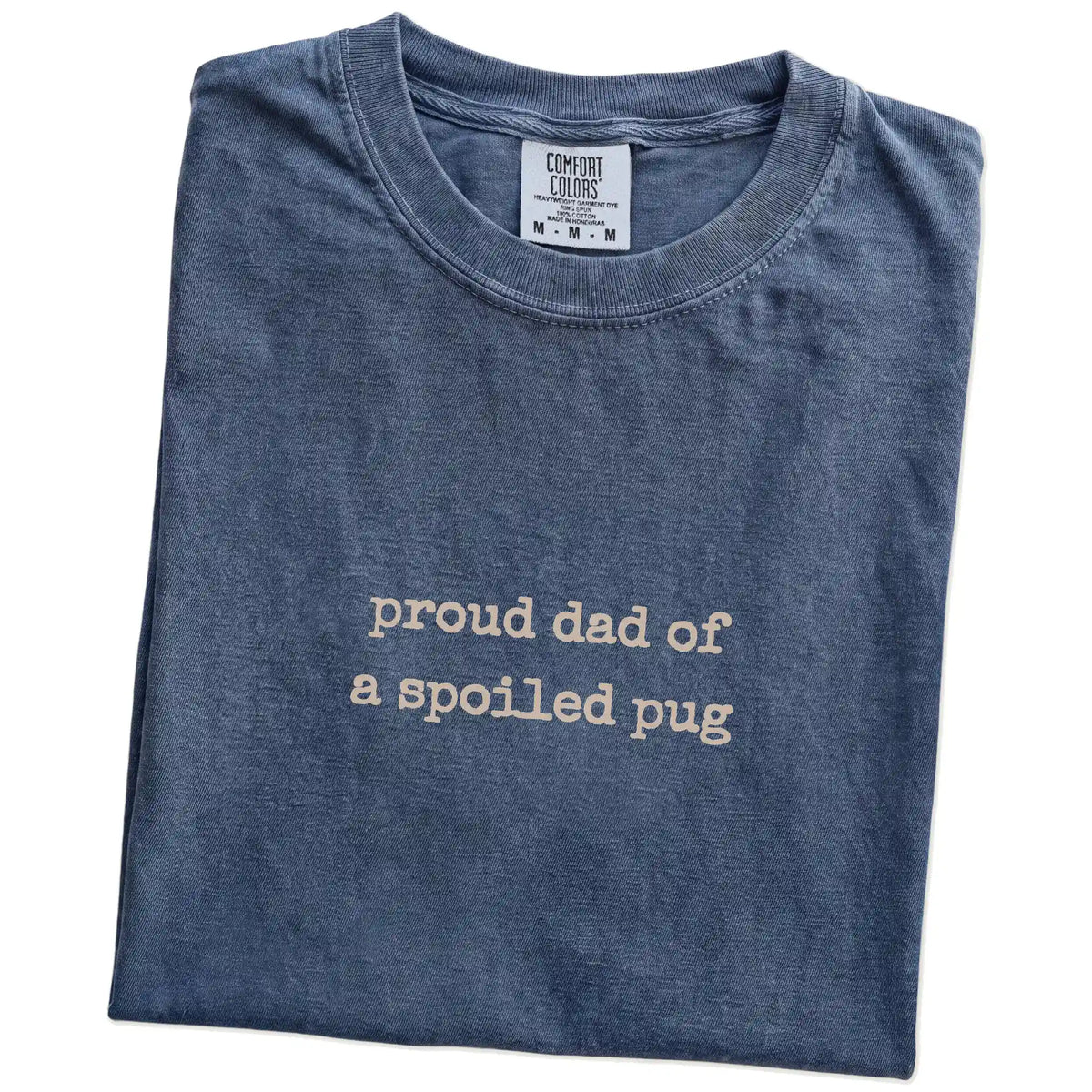 Folded Denim Comfort Colors® T-shirt showing proud dad of a spoiled pug lettering