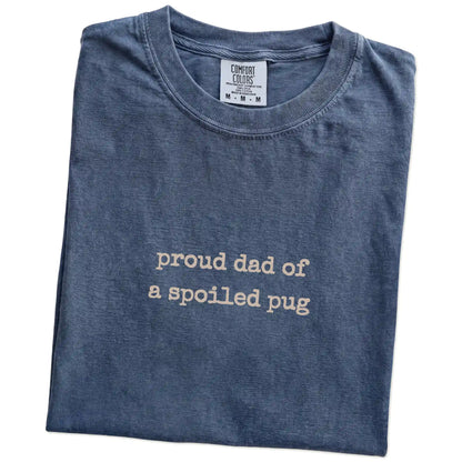 Folded Denim Comfort Colors® T-shirt showing proud dad of a spoiled pug lettering