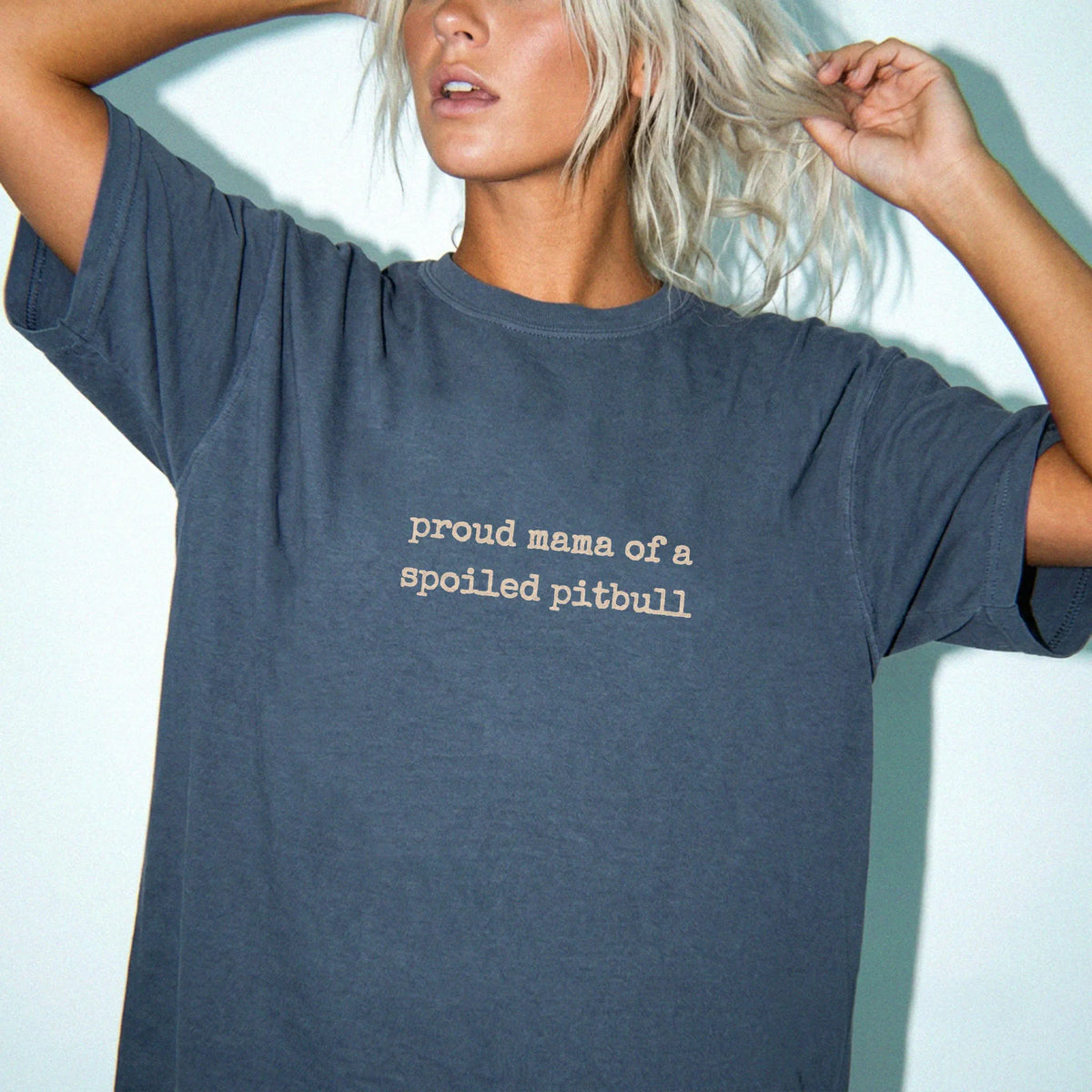 Model wearing a Denim Comfort Colors® T-shirt featuring Proud Mama of a Spoiled Pitbull lettering
