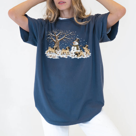 Pug puppies playing in snow with a snowman on a Denim T-shirt worn by a model