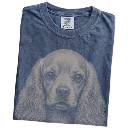 Folded Denim Comfort Colors® T-shirt showing a realistic drawing of a Cocker Spaniel