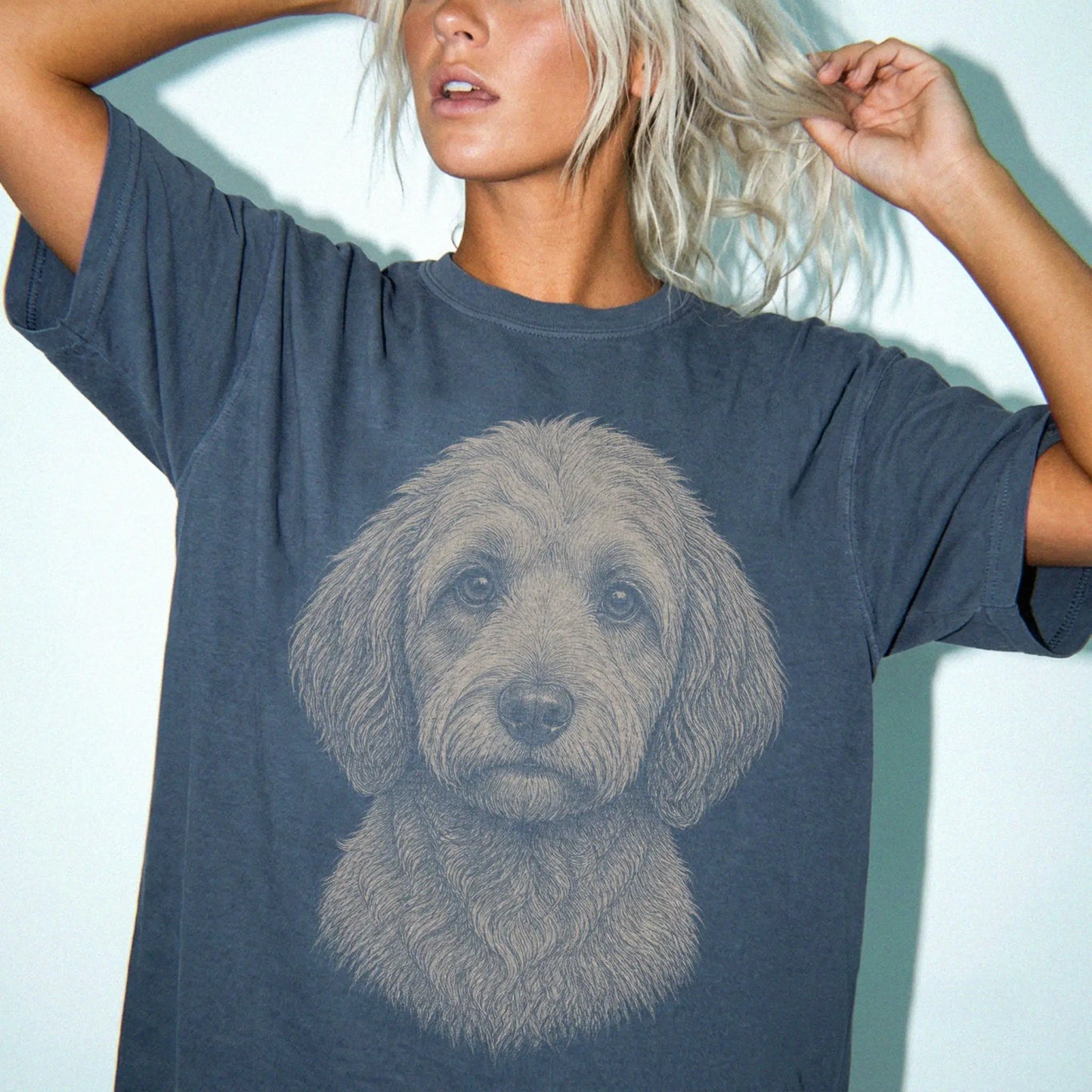 Model wearing a Denim Comfort Colors® T-shirt with a realistic drawing of a Labradoodle