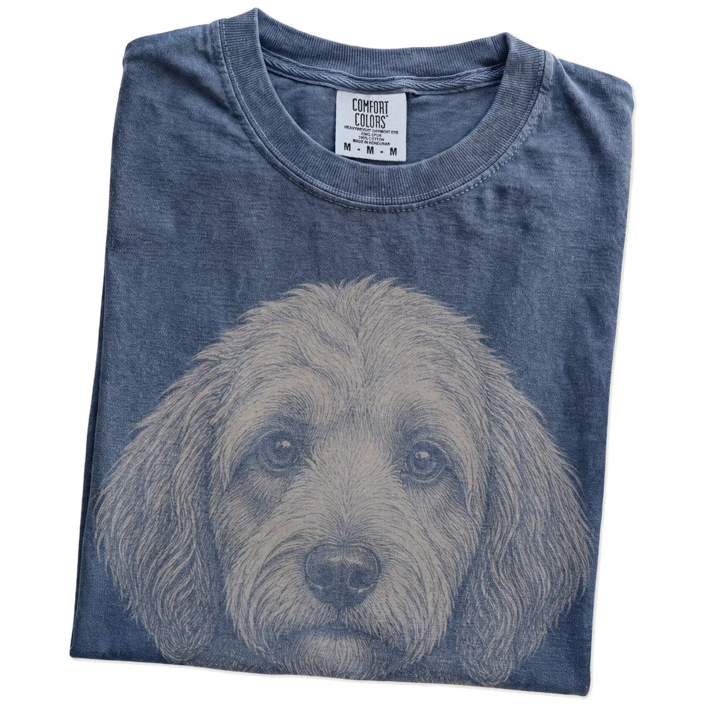 Folded Denim Comfort Colors® T-shirt showing a realistic drawing of a Labradoodle