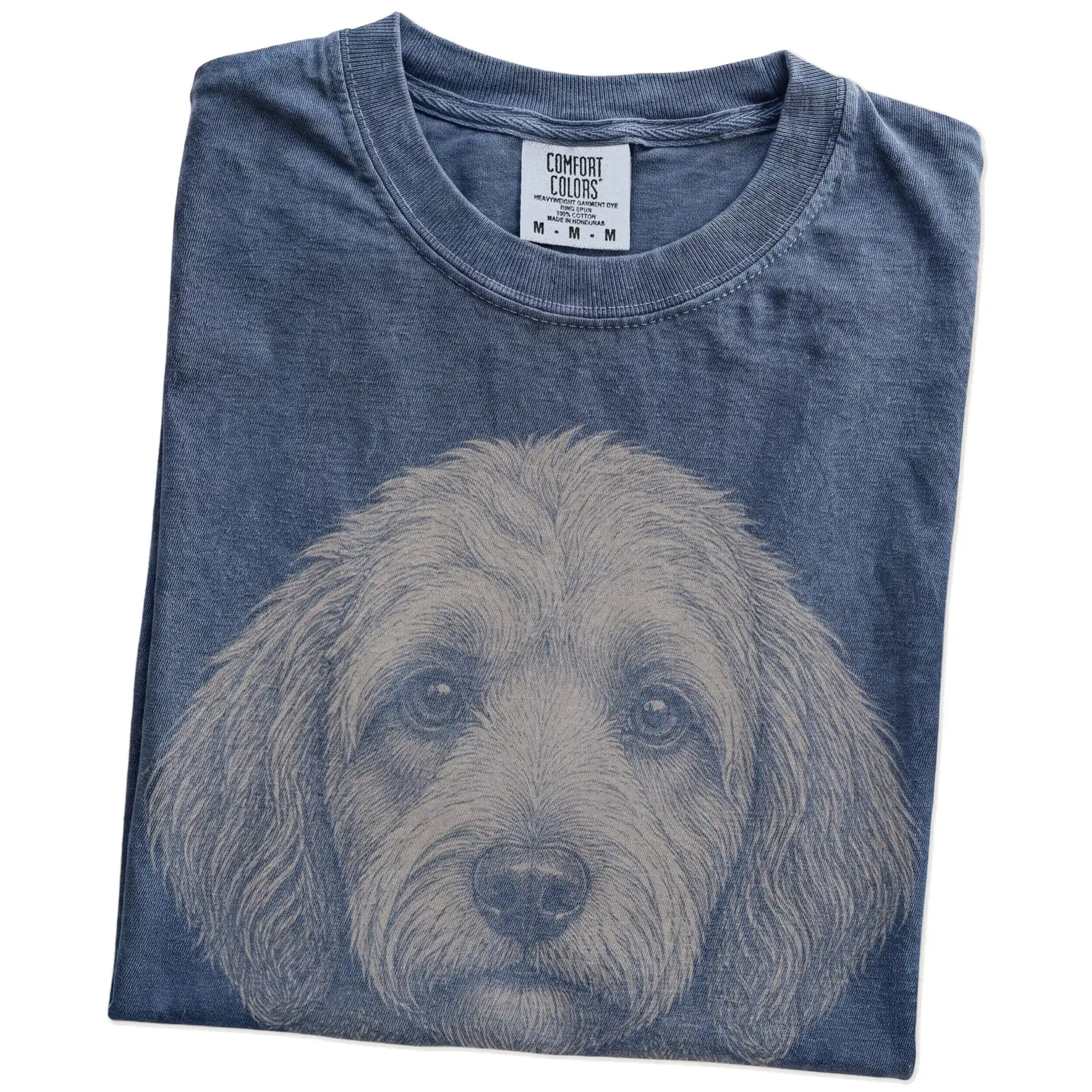 Folded Denim Comfort Colors® T-shirt showing a realistic drawing of a Labradoodle