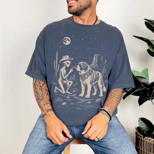 Model wearing a Denim Comfort Colors® T-shirt with cowboy alien fist-bumping a saint bernard beneath the moon